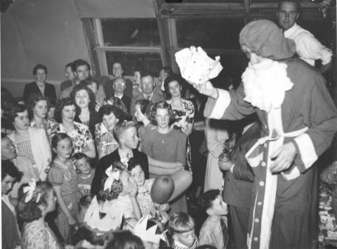 Santa giving presents to the kids at an FJ Christmas Party in the 50s.  Photo: Jones Family Collection