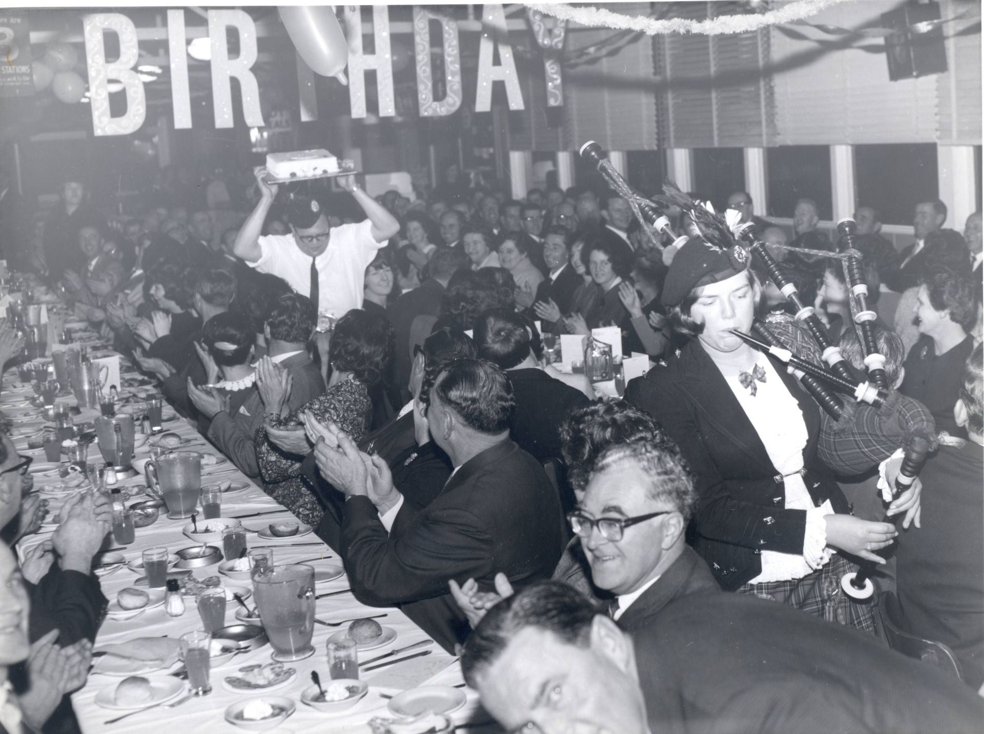 Maurice Bennoun holding the birthday cake above his head.  Maurice was the French chef in the FJ canteen.  Photo: shared by Yola Bennoun.  