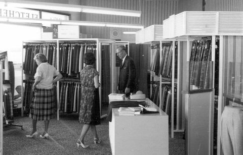 Jack Vicars watches his wife buying a FJ kilt made from Vicars worsted tartan.  Photo: Jones Family Collection 