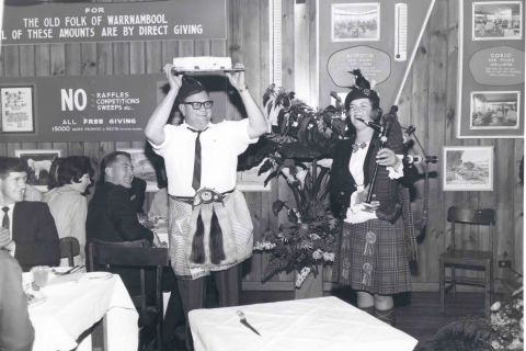 Dancing with the cake, Maurice Bennoun and unknown piper.  Photo: Alex Wilkins